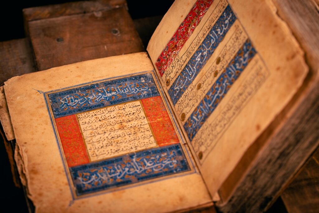 Close-up of an ancient manuscript showing detailed Arabic calligraphy.