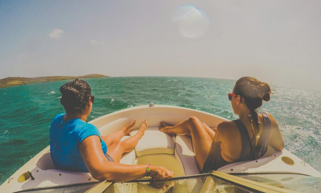 Two people enjoying a sunny day on a boat in Cabo Rojo, Puerto Rico's vibrant waters.