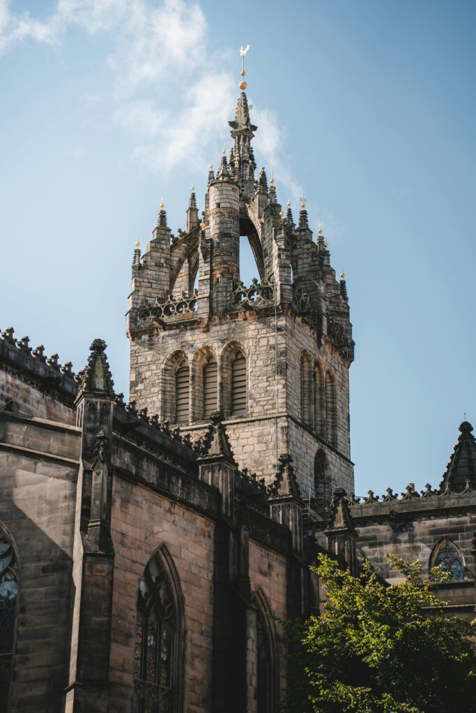 Majestic view of St. Giles' Cathedral tower against a clear sky in Edinburgh, Scotland.