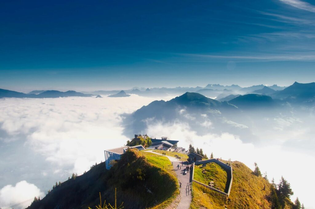 A stunning view from Stanserhorn in Switzerland, showcasing clouds, mountains, and scenic landscapes.