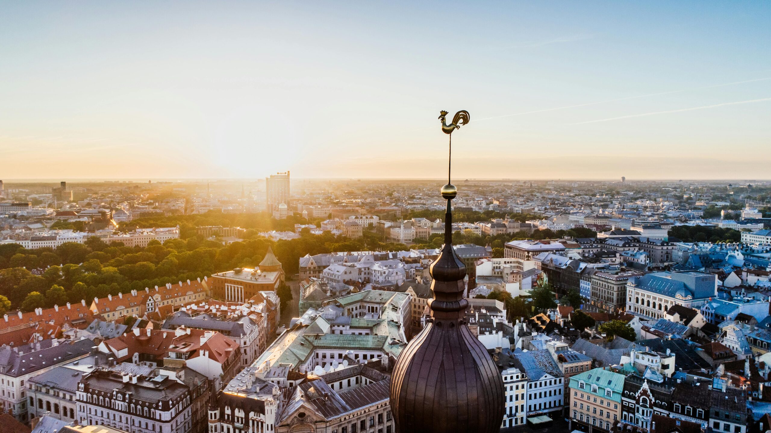 Stunning aerial view of Riga, Latvia with the sun rising over the historic cityscape and skyline.