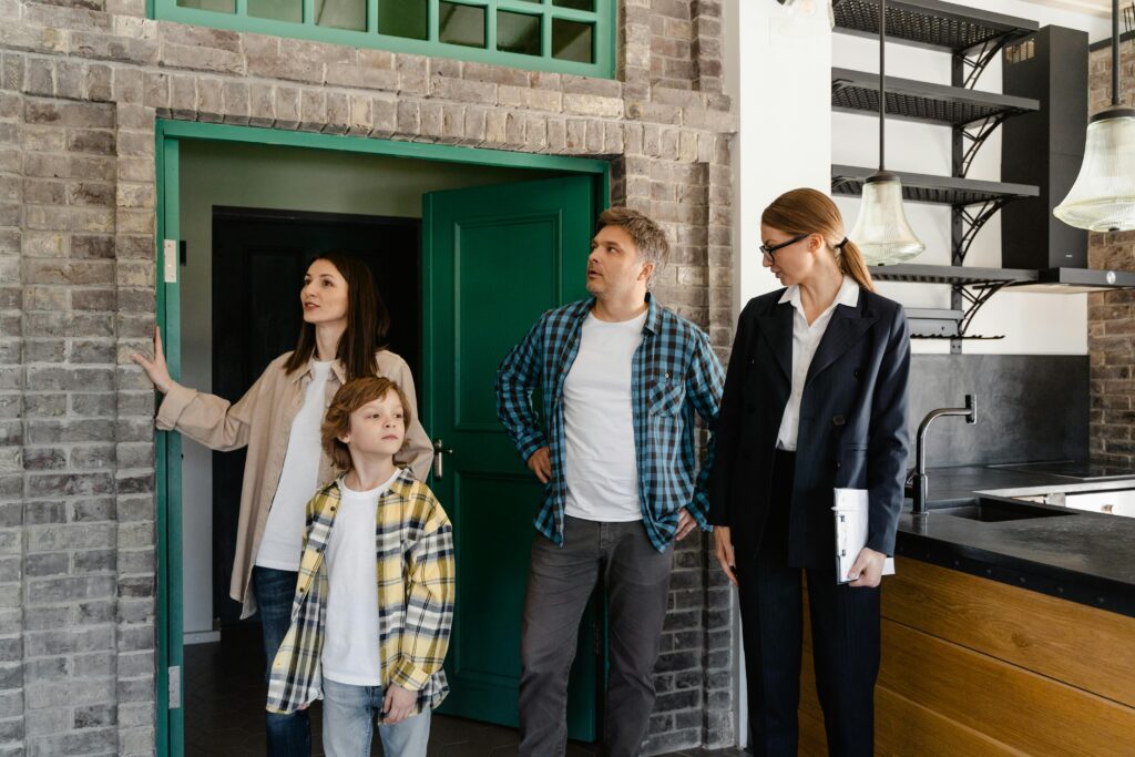 Family exploring potential new home guided by a real estate agent.