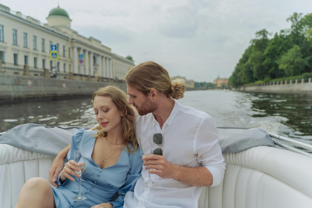 A couple enjoys a romantic boat ride on the Neva River, Saint Petersburg, with champagne.