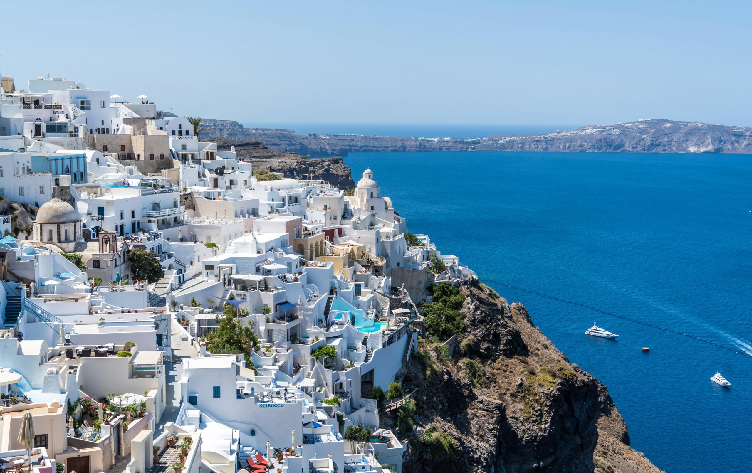 Beautiful Santorini houses overlooking the Aegean Sea on a sunny day.