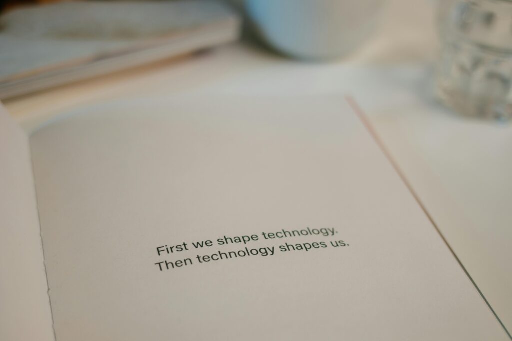 Open book with quote on technology's influence, perfect for tech inspiration.