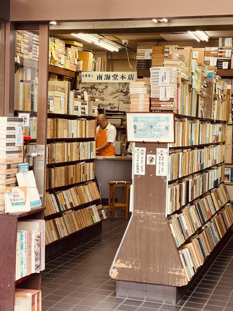 Explore a charming Tokyo bookstore filled with vintage books and warm ambiance.