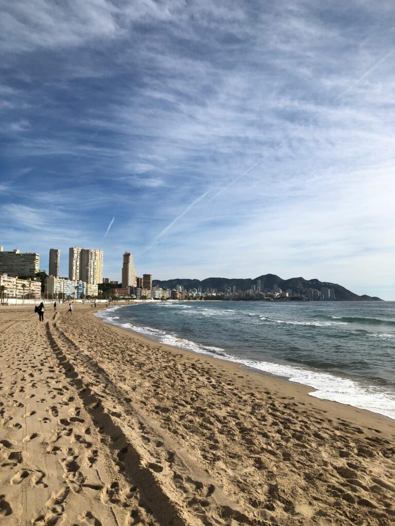 Explore the beautiful coastline of Benidorm, Spain with sandy beaches and stunning city skyline views.