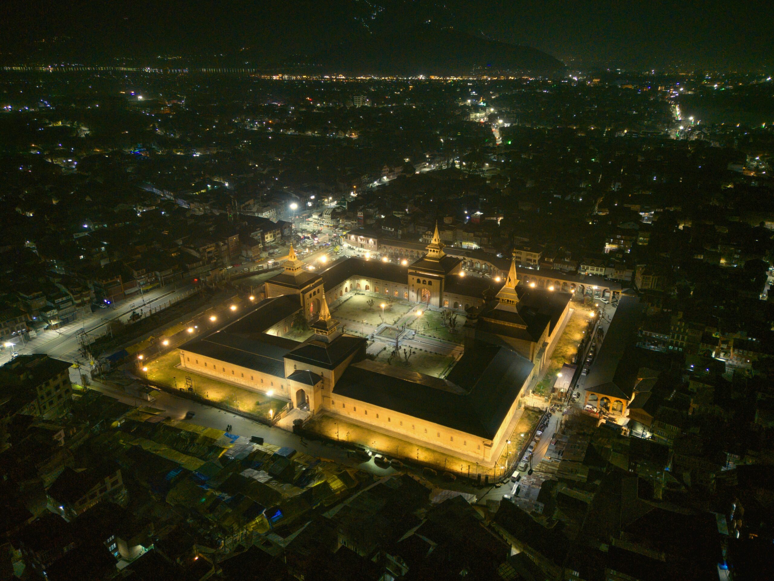 Stunning aerial night view of the illuminated Jamia Masjid in Srinagar.
