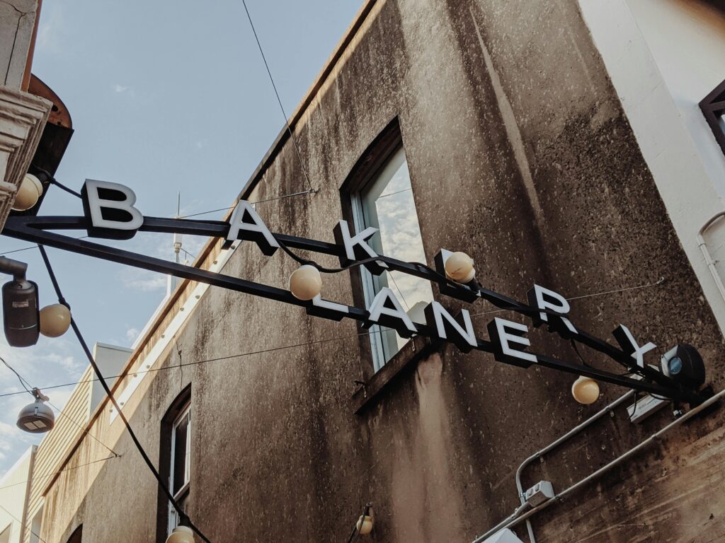 Vintage-style sign in Bakery Lane, Brisbane, showcasing urban charm and architectural detail.