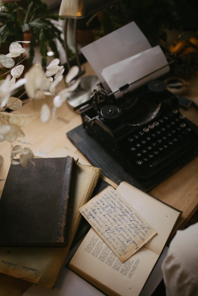 Cozy vintage writing desk with typewriter, books, and handwritten notes, ideal for creativity.
