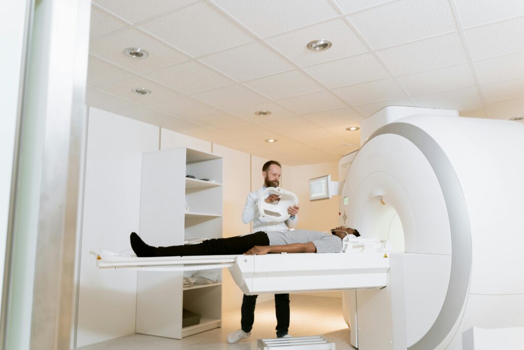 A doctor assists a patient during an MRI scan in a modern medical clinic.