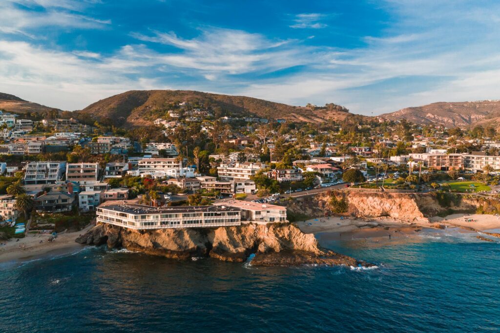 A stunning aerial shot of Laguna Beach's coastline, capturing the charming hillside community and ocean waves.