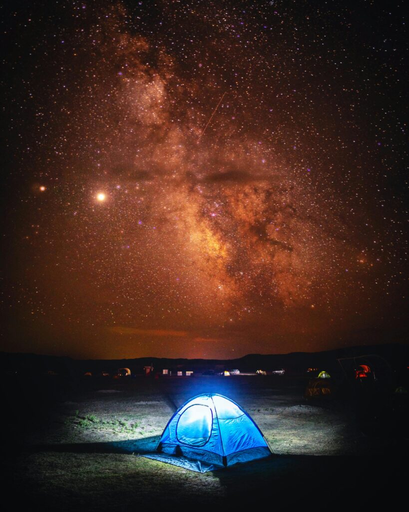Capture the beauty of the Milky Way above a serene campsite in South Dakota.