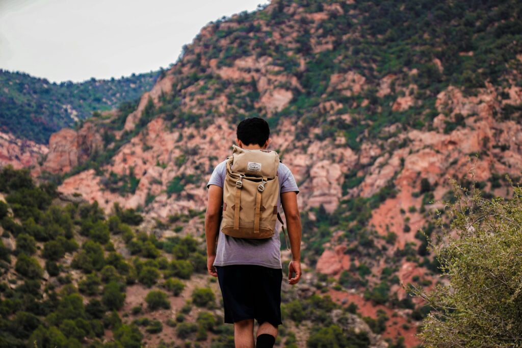 A lone backpacker hikes a stunning mountain trail, embracing nature and adventure.