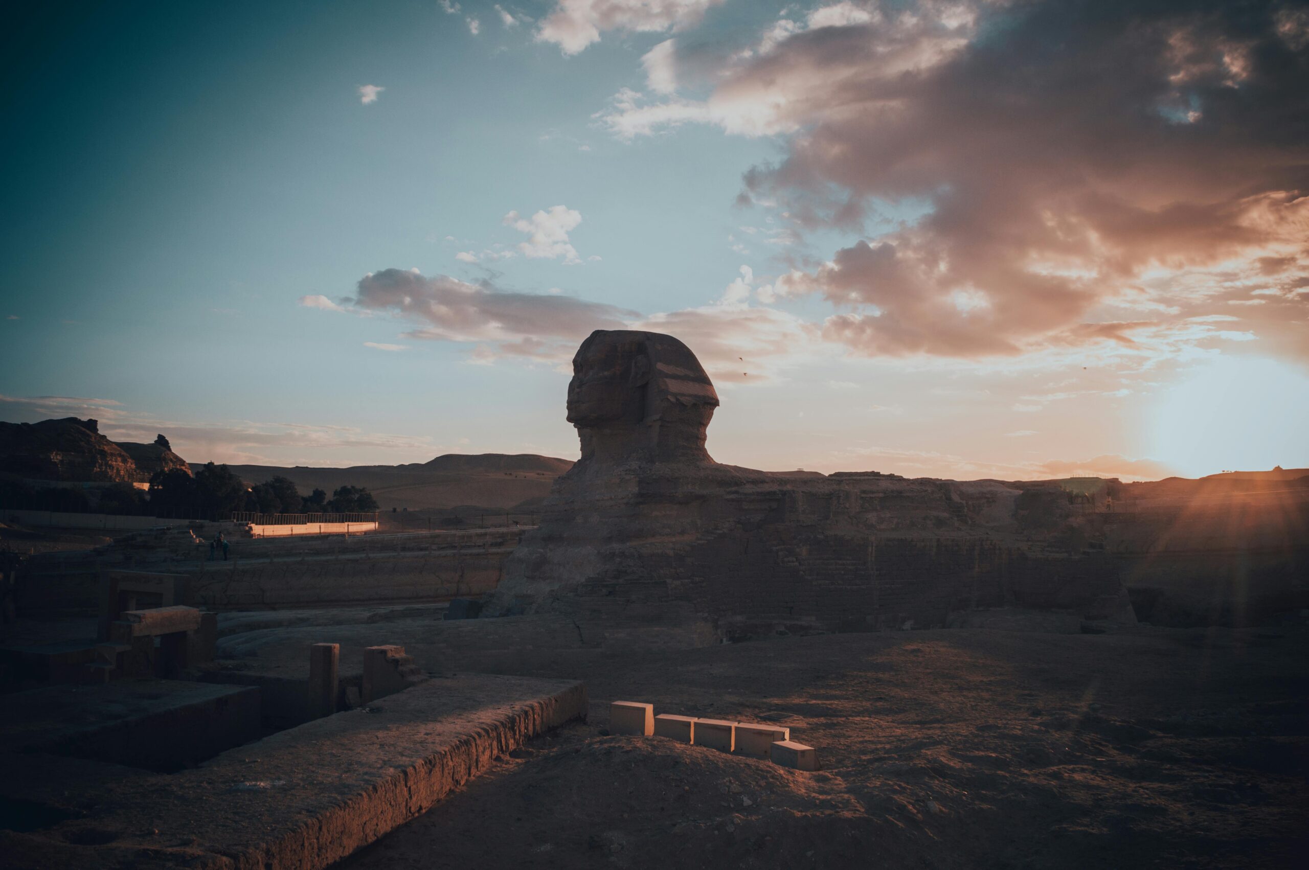 Majestic sunset over the Great Sphinx of Giza in the Egyptian desert, capturing its iconic silhouette.