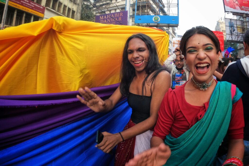 A vibrant pride parade in Kolkata with participants celebrating diversity and love.