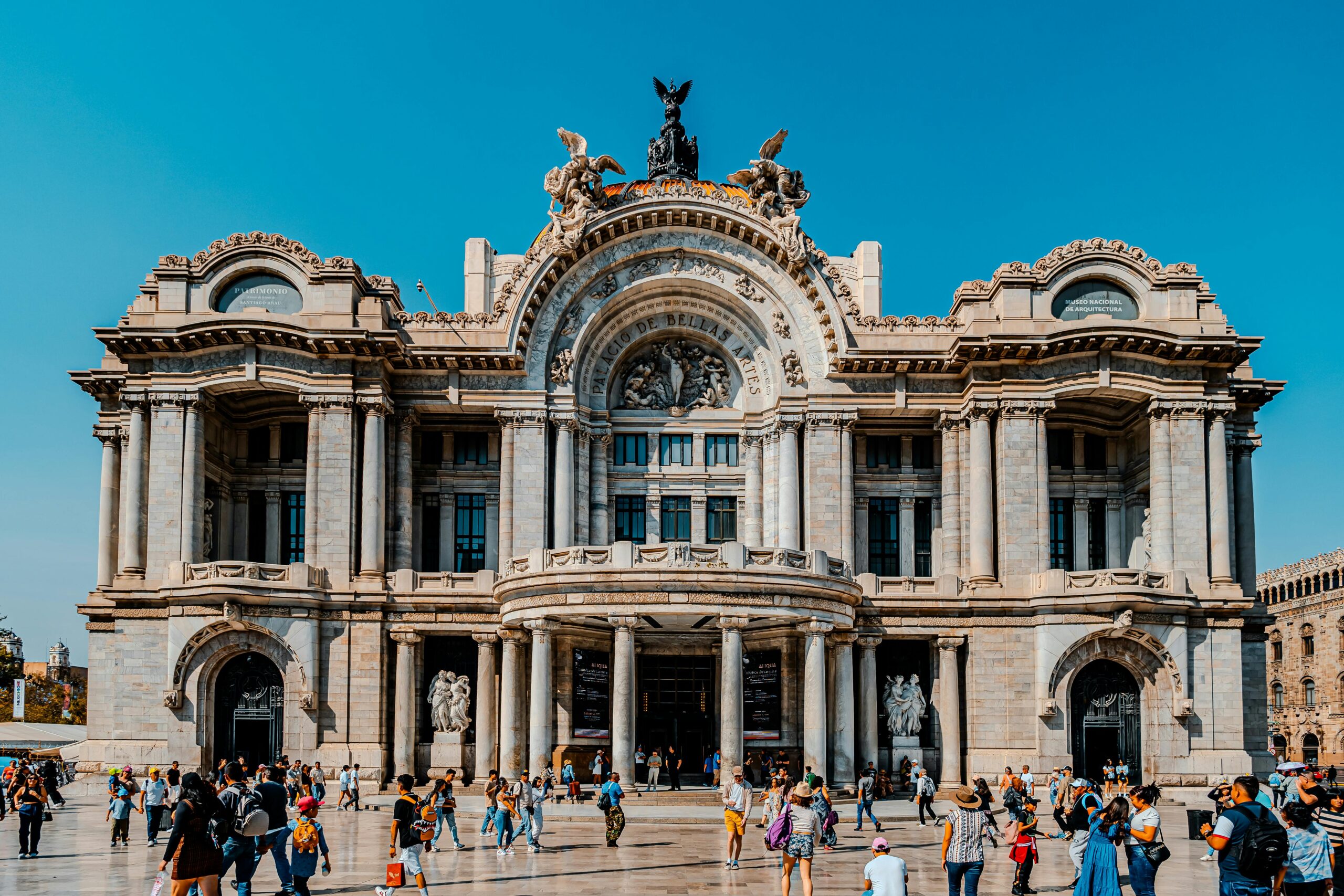 The iconic Palacio de Bellas Artes with bustling crowds in Mexico City.
