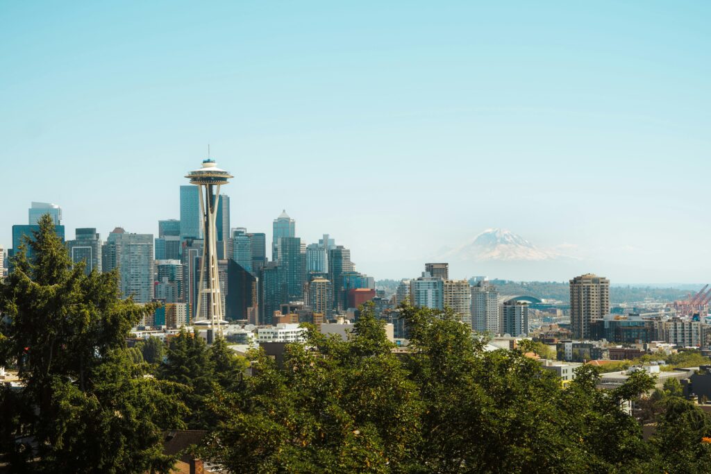 A stunning view of Seattle's skyline featuring the Space Needle and Mount Rainier in the distance.