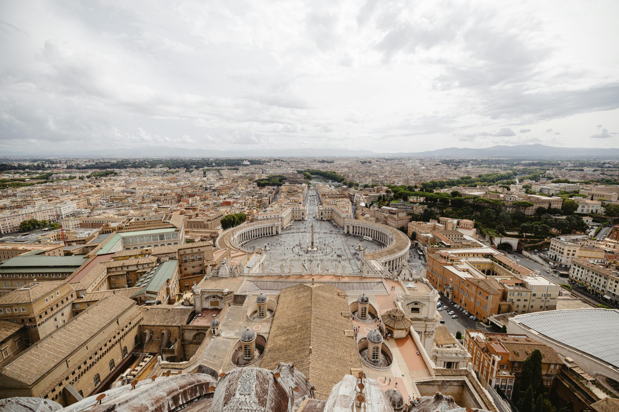 Breathtaking aerial view of St. Peter's Square in Vatican City on a cloudy day.