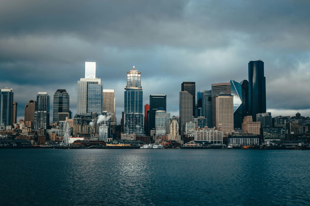 Dramatic skyline of Seattle cityscape with moody clouds over Puget Sound.