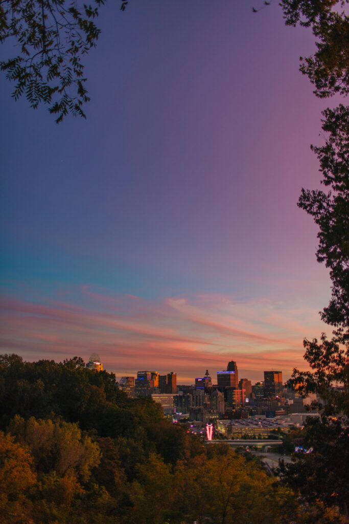 A breathtaking view of Cincinnati's skyline during twilight, capturing the vibrant hues of a sunset.