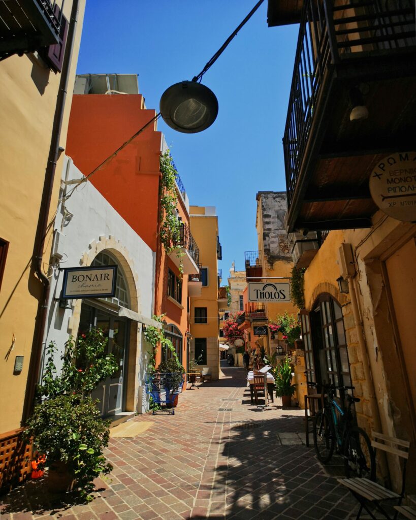 Explore a vibrant pedestrian street in Chania's Old Town, featuring colorful buildings and local shops.