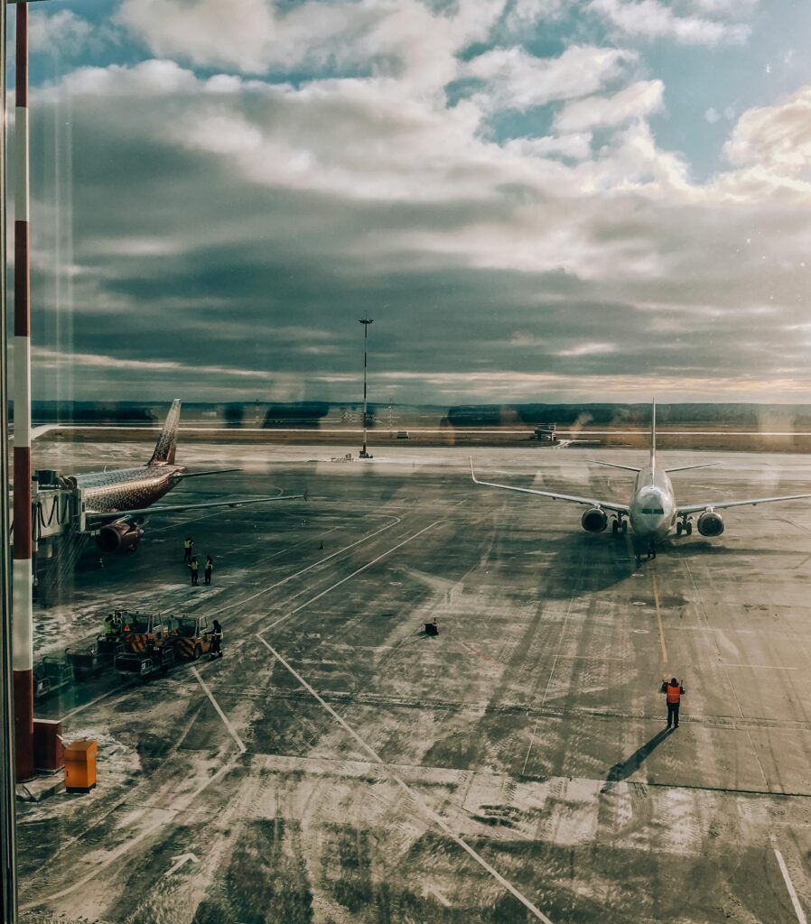 A tranquil scene capturing an airplane on a frosty tarmac during sunrise at an airport.