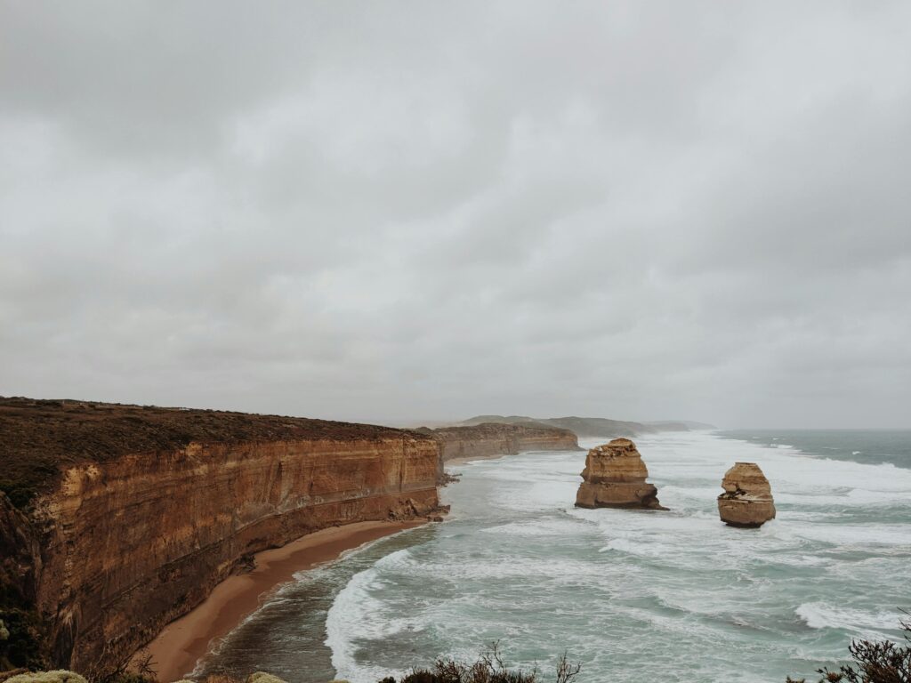 Captivating view of Anglesea's rocky coastline with dramatic skies and ocean waves.
