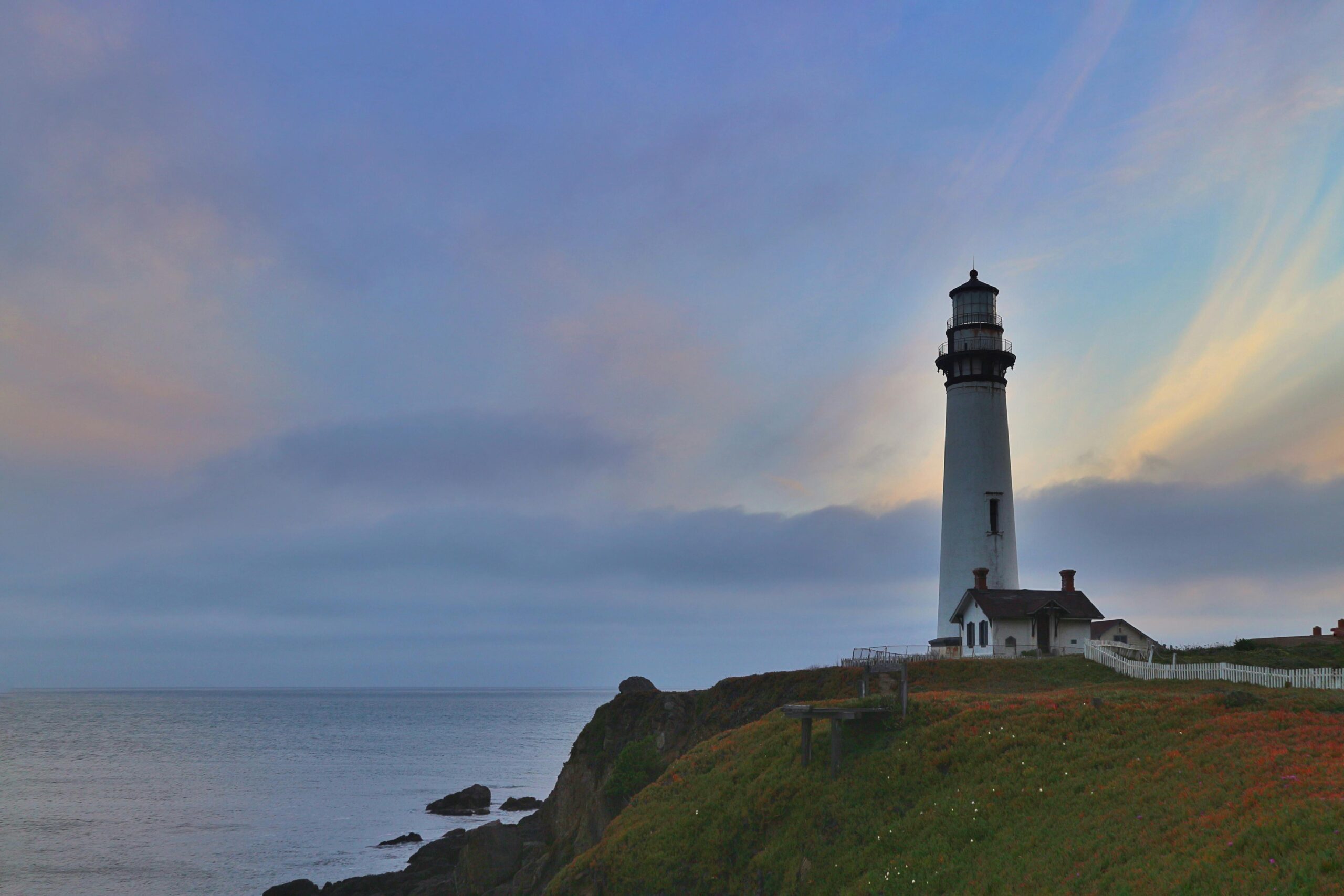 Beautiful shot of Pigeon Point Lighthouse at dusk with vibrant sky and ocean view in California.