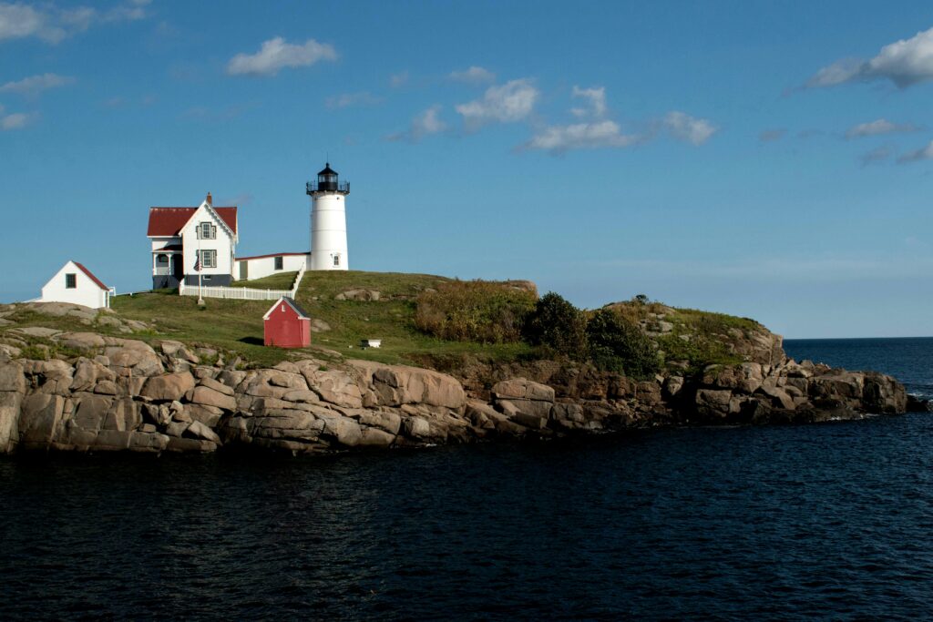 Scenic view of Nubble Lighthouse on the rocky coast of York, Maine.