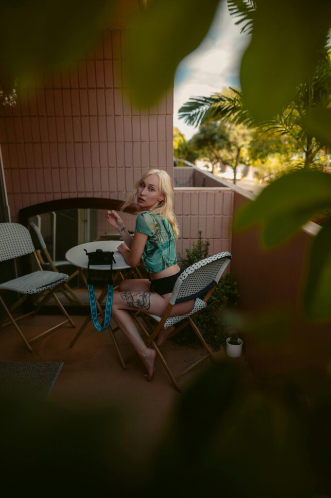 Woman enjoying a peaceful moment on a Hawaiian balcony, surrounded by nature.