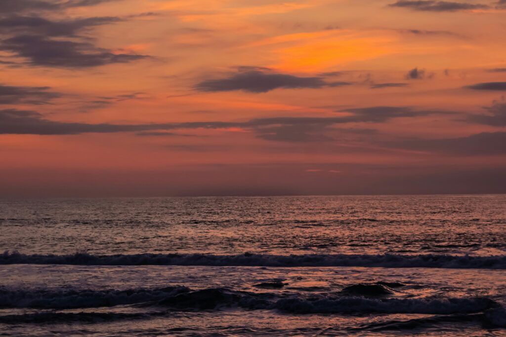 Vibrant sunset with waves at Ocean City beach, capturing the serene beauty of the ocean.