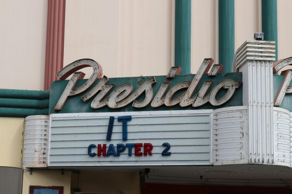 Retro theater marquee displaying 'IT Chapter 2' at Presidio. Iconic cinema facade.