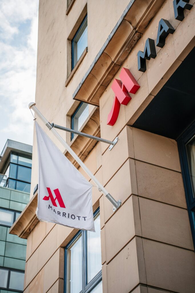 Exterior view of a Marriott Hotel with a logo flag displayed prominently.