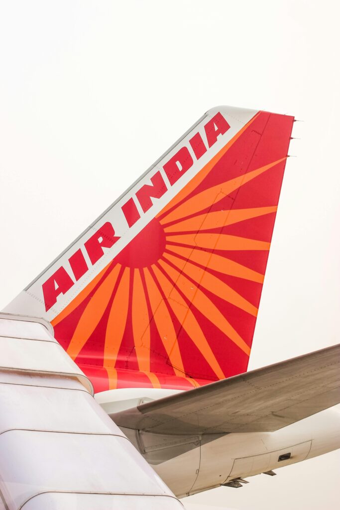 Close-up of Air India's aircraft tail fin featuring the iconic red and orange design.