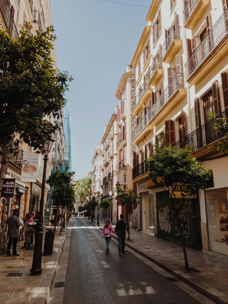 Scenic street view in a European city with tourists enjoying a walk amidst classic architecture.