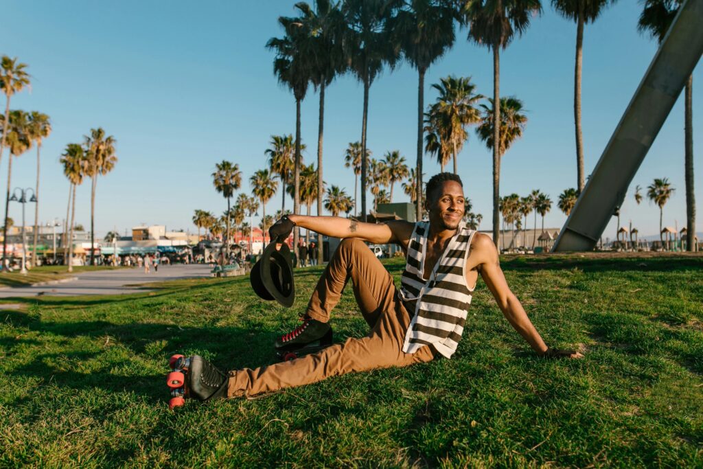 Young adult enjoying a sunny day roller skating at Venice Beach.