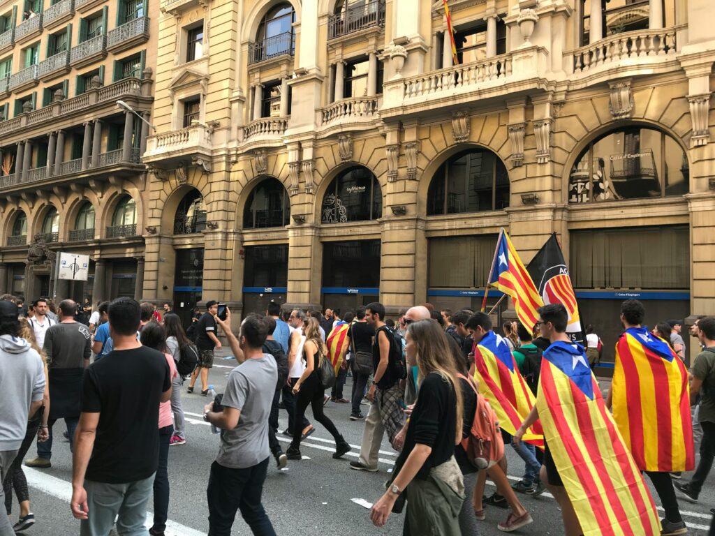Protesters march with Catalan flags in Barcelona, emphasizing independence activism.