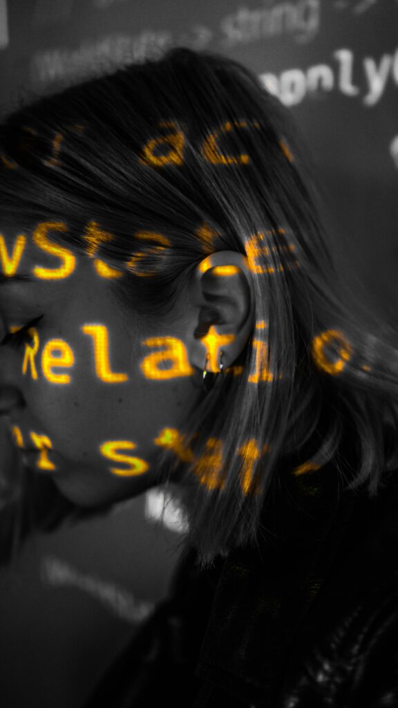 Black and white side view of a woman with projected text highlighting technology themes.
