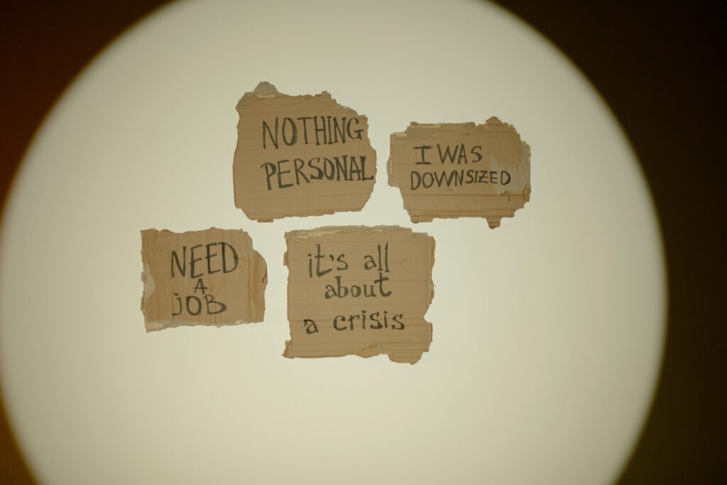 Cardboard signs convey job loss and economic crisis message, ideal for articles on unemployment.