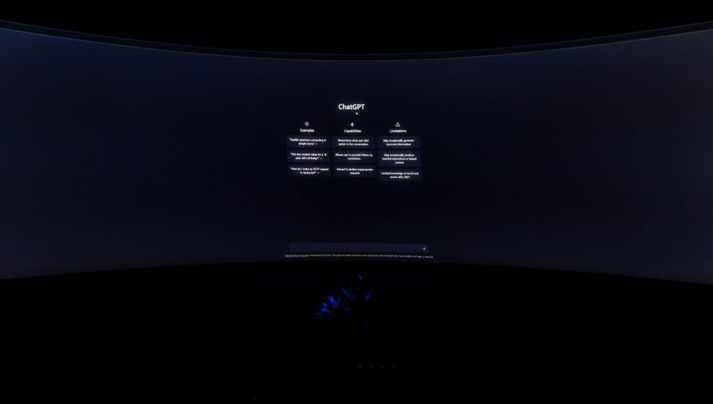 A dimly lit computer screen showing the ChatGPT interface in a dark setting.