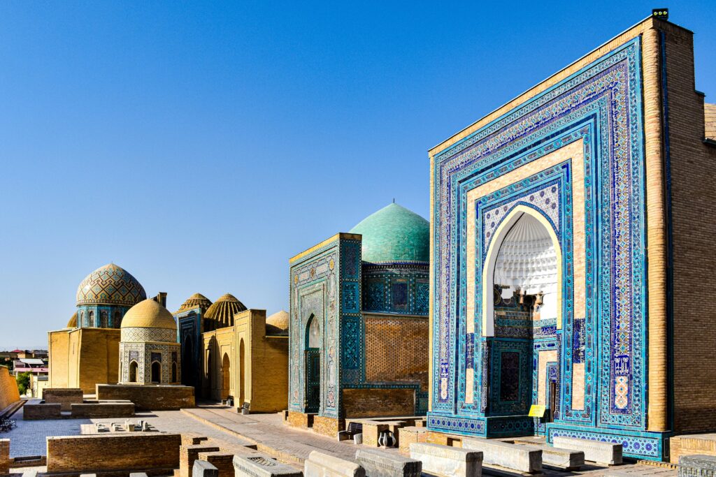 Explore the vibrant mosaics and historic domes of the Shah-i-Zinda complex in Samarkand, Uzbekistan.
