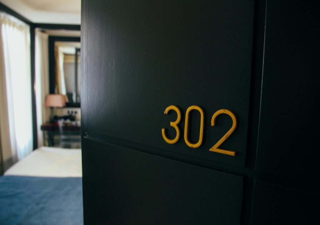 Stylish hotel room with room number 302 and elegant interior design.