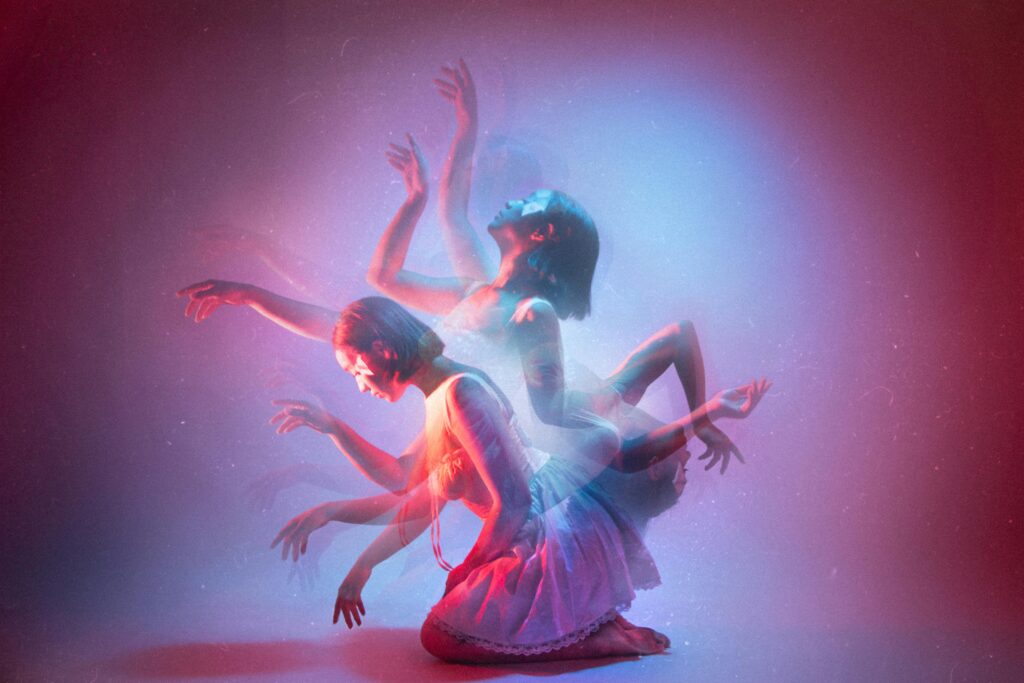 Artistic dance photo in studio with kinetic light effects and blurred motion.
