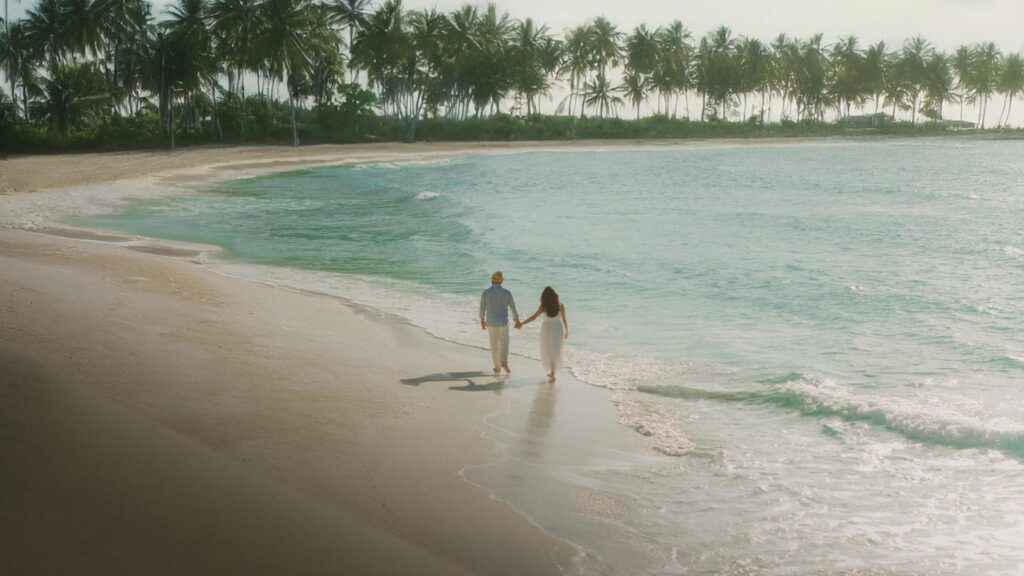 beautiful couple walking at the beach.