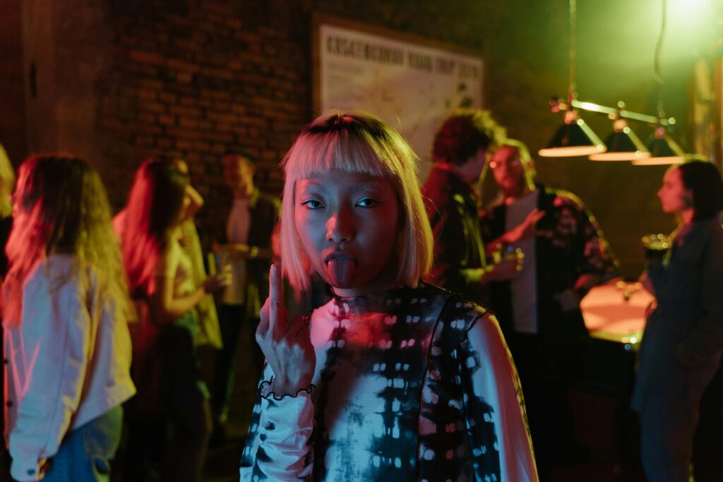 Vibrant nightlife party scene with diverse people enjoying drinks and music indoors.