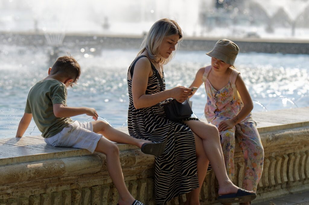 family, fountain, children, park, mother, kids, nature, relaxation, outdoors, sunny, tourism, recreation, snapshot, summer, water, basin, edge, border, smartphone