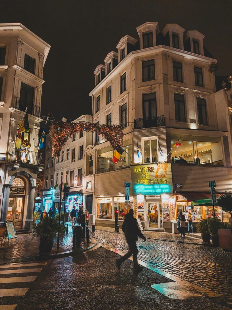 Illuminated streets of Brussels showcasing vibrant nightlife and architecture.