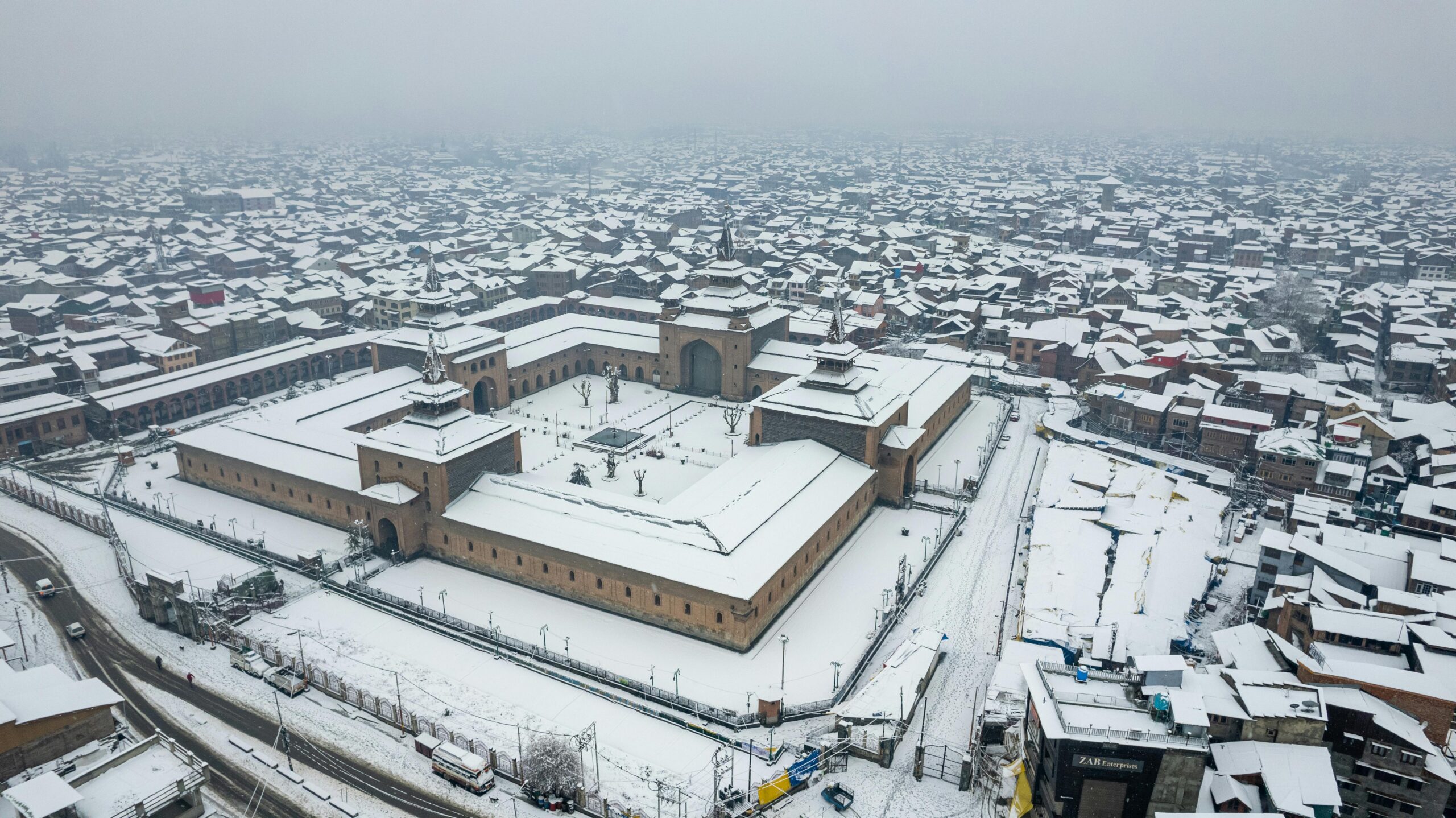Aerial shot of Srinagar's Jamia Masjid covered in fresh snow during winter.
