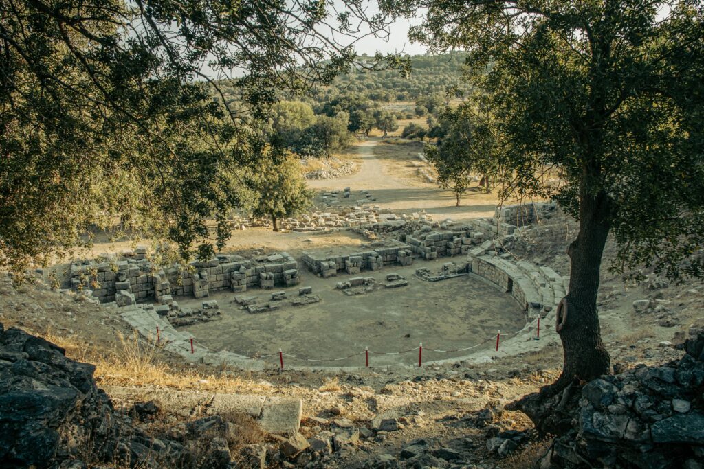 Explore the rustic beauty of ancient amphitheater ruins set in a lush, serene landscape.